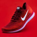 unpaired red Nike sneaker