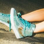 person showing teal Nike shoes