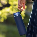 person holding blue plastic cup